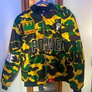 Camo puffer jacket with lettering. Adult size small brand is ODE.